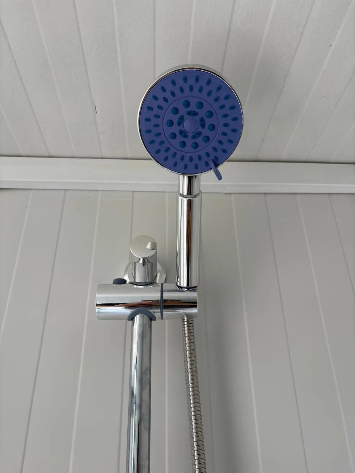 Shower head inside a portable handicap toilet unit