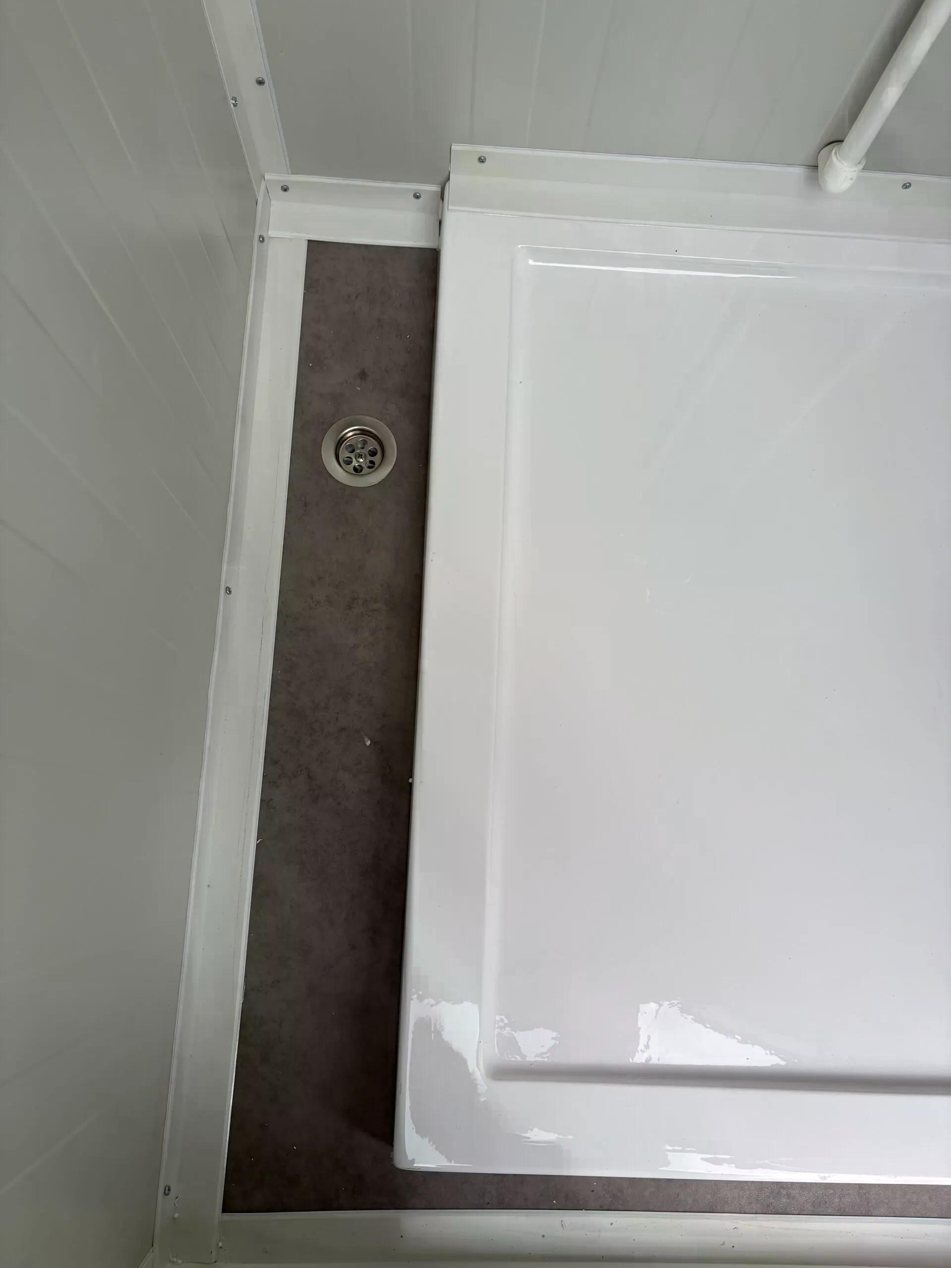 Dual portable shower unit floor drainage