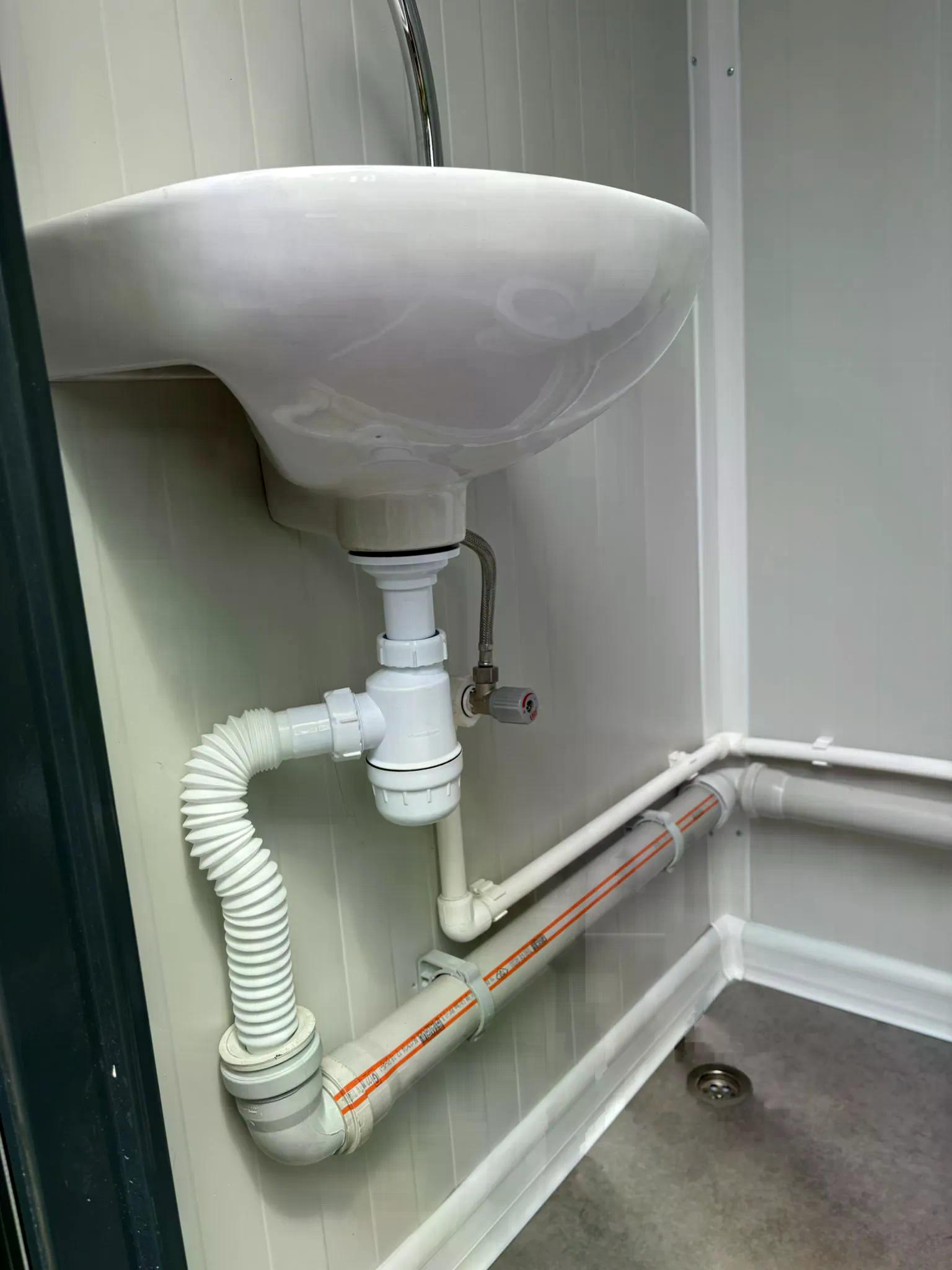 Dual portable toilet unit sink and piping