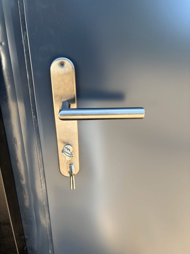 Fuse and door handle inside a portable shower unit for camping