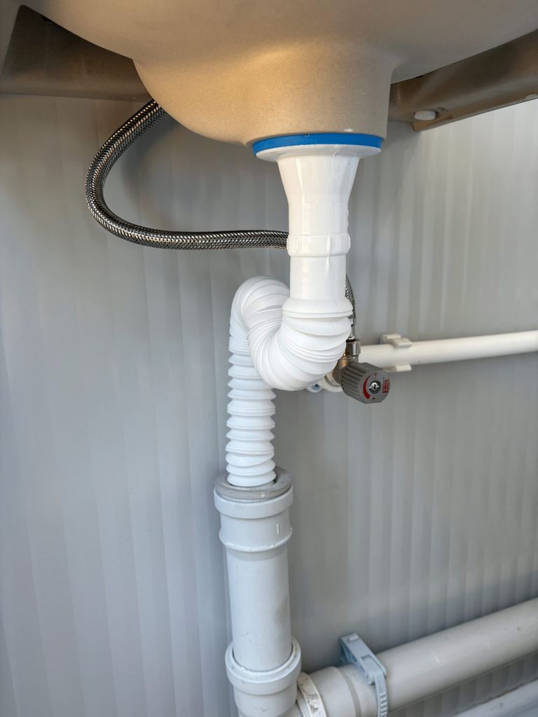 Drainage piping of a portable toilet unit for camping