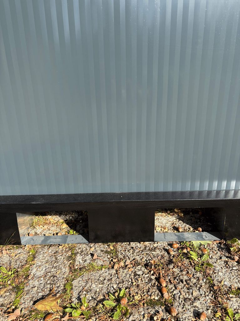 Forklift slots under a portable toilet unit for camping