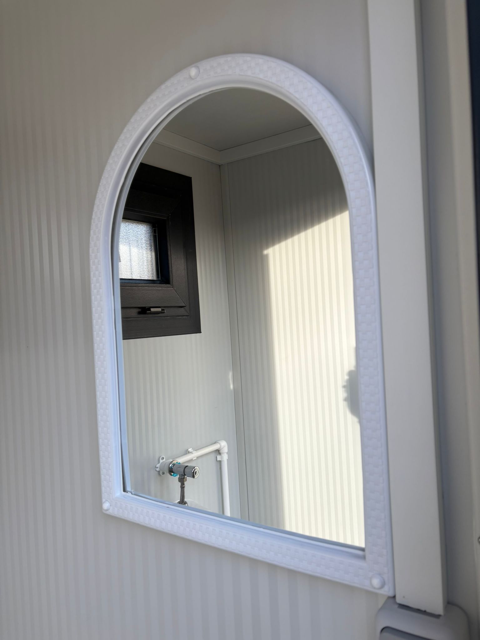 Spiegel in een toilet- en urinoirunit.