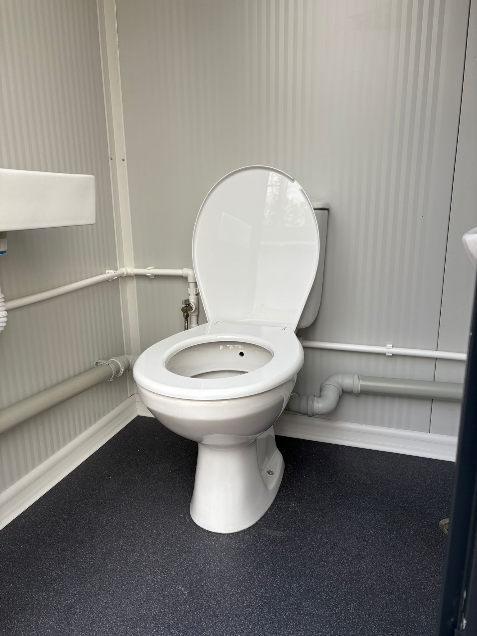 Toiletpot in een single toiletunit met urinoir.